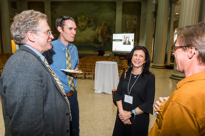Attendees Professor John Brisson, Jesse DeLaughter, and IMA award  winner Deb Payson, all from SUTD, visit with Rob Stoner of the Energy Initiative during the reception after the Infinite Mile Award ceremony.